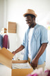 © pressmaster - Owner of modern fashion studio or atelier packing one of orders into box before sending it to client