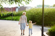 © Maria Sbytova - Beautiful granny and her little grandchild walking together in park