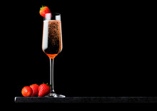 Elegant Glass Of Pink Rose Champagne With Strawberry On Top And Fresh Berries On Black Marble Board On Black Background. Space For Text