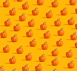 Wall Mural - Autumn orange pumpkins on an orange background