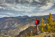 © xfasss88 - Young Man Traveler relaxing outdoor with rocky mountains on background Autumn vacations and Lifestyle