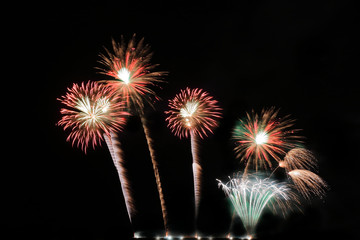 Festive colorful fireworks on night sky background. Celebratory holiday