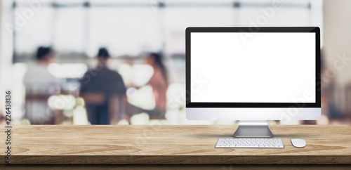 Cuadros en Lienzo Blank screen desktop computer on wooden table top with blur people working at creative office bokeh background,Mock up for display or montage of design