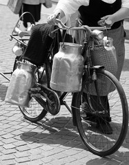 Poster - woman carrying milk cans and black and white effect