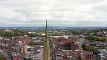 Fast Panning Aerial View Of A Church Spire In A City Centre.