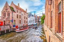 Boat Trip On Canal Of Bruges. Popular For Tourists Who Visit Belgium.