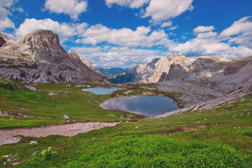 Beautiful mountainscape with cloudy sky and two small mountain lakes. Tre Cime di Lavaredo National park, Dolomites, Italy.