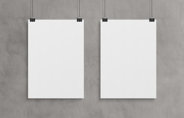 Aufkleber - Two blank white poster hanging up with clips mockup