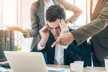 Businessman worry about his job with serious boss discussing while commenting a financial report document at meeting 