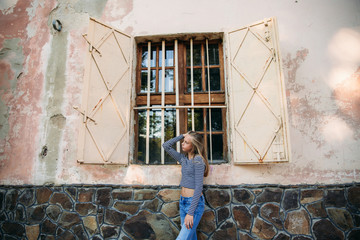 Wall Mural - blonde teenage girl in striped blouse on the backgrountd of green tree