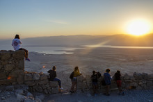 People At Masada Fortress Looking At The Sunrise Over The Dead Sea, Israel.