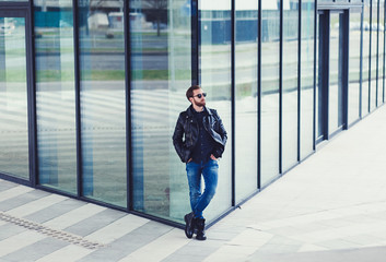 Wall Mural - Photo of handsome stylish man in black leather jacket.