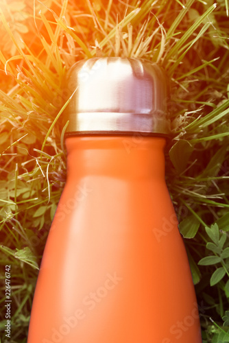 Download Stainless Thermos Water Bottle Orange Color Mockup Isolated On Green Grass Background With Sunlight Effect Glossy Aluminum Vacuum Thermo Tumbler Flask Stock Photo Adobe Stock