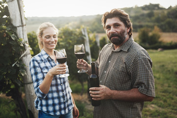 Wall Mural - Couple in vineyard before harvesting