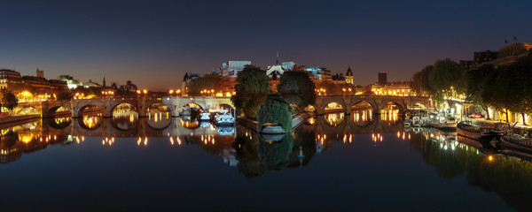 Panoramic view of Ile de la Cite and Pont Neuf at sunrise in Paris, France, as seen from Pont des Arts