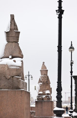 Wall Mural - St. Petersburg in the winter snowy day. View of the ancient sculptures of Egyptian Sphinxes which are about 3.5 thousand years old on the Neva embankment on Vasilyevsky Island