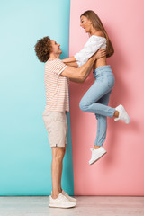 Wall Mural - Full length of smiling young couple