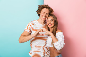 Wall Mural - Smiling young couple standing