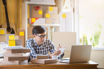 Wall Mural - Asian man working on laptop at home