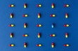 © Alexandre - Graphic colourful pill composition on a solid blue background