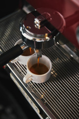 close-up view of coffee maker and two mugs with espresso