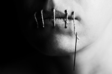 artistic conceptual photo of a woman with stitches in lips