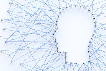 Poster - Human head shape made from a large grid of pins connected with string. Communication technology and mental health concept