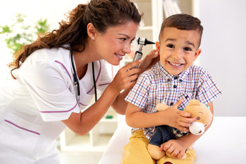 Dedicated doctor examining her patients ear