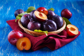 Wall Mural - Fresh plums with leaves