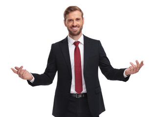portrait of handsome businessman smiling and making an inviting gesture