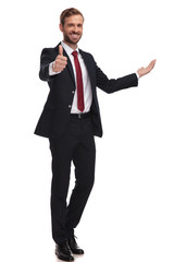 joyful businessman invites and makes thumbs up sign