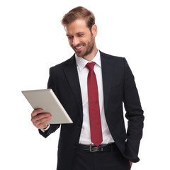 Wall Mural - portrait of relaxed and joyful businessman looking at tablet