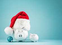 Christmas Finances Piggy Bank Wearing Santa Hat