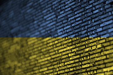 ukraine flag is depicted on the screen with the program code. the concept of modern technology and s
