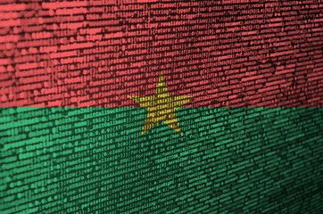 burkina faso flag is depicted on the screen with the program code. the concept of modern technology 