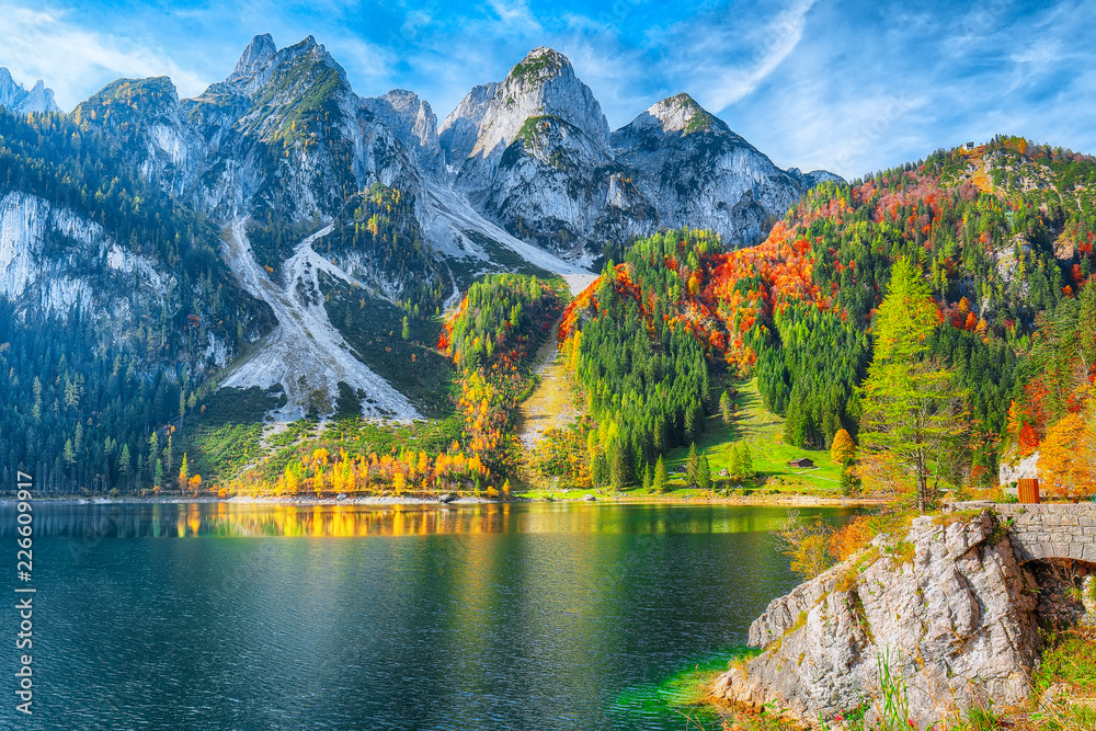 autumn scenery with Dachstein mountain summit reflecting in crystal clear Gosausee mountain lake - obrazy, fototapety, plakaty 
