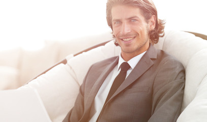 close-up of smiling businesswoman working with laptop in living room.