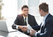 © ASDF - close-up.side view.the handshake business partners at your Desk.