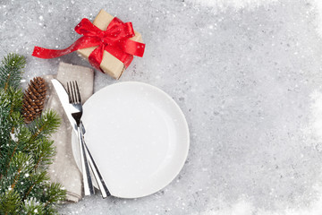 Christmas table setting with gift box and xmas tree