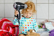 © Irina Schmidt - Cute little toddler girl making hairs with hair dryer. Adorable healthy baby child with wet hairs after taking bath. Beautiful girl having fun with toy