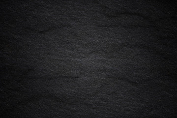 Dark grey black slate background or natural stone texture.