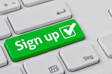 Wall Mural - a keyboard with a green button - sign up