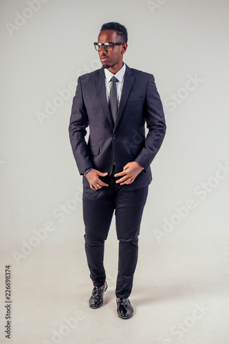 Cuadros en Lienzo portrait african businessman american man in stylish suit wear glasses studio sh