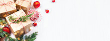 Christmas Gift Boxes Collection With Evergreen Branches, Candy Cane Christmas Rope And Red Christmas Balls. Angle View. Copy Space, Banner For Website.