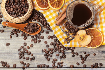 Cup Of Coffee And Coffee Beans On Table.