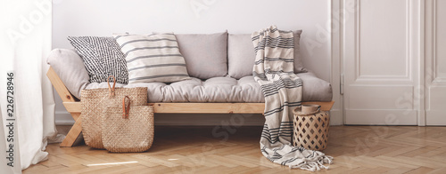 Panorama of pillows and blanket on wooden beige couch in white flat interior with door Tableau sur Toile