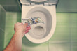 concept of senseless waste of money, loss, useless waste, large water costs, in the toilet wash a thousand dollars bill