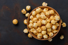 Caramel Popcorn In Bowl On Dark Table Background