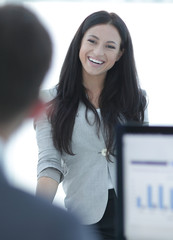 successful business woman standing near a work table