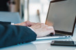 © Sergey - Businessman's hands using laptop for work and mobile phone at office. Concept of using modern devices for work and maintaining communication.